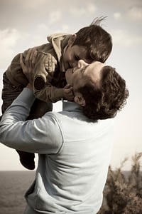 Father Holding Up Child