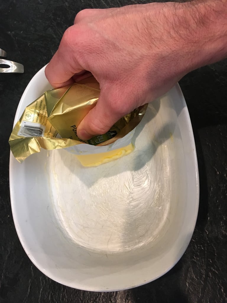 Oiling bottom of pan with butter 